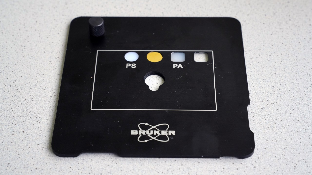 The validation plate is Bruker's standard accessory for the HYPERION II IR microscope
